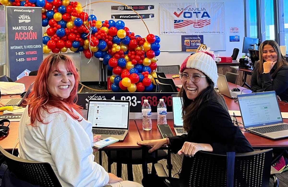 Mi Familia Vota organizers at a table with laptops